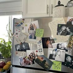 a refrigerator covered in magnets and pictures