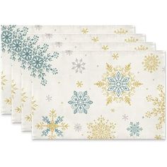 four napkins with snowflakes on them in gold, blue and green colors