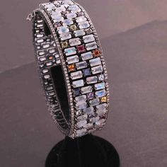 One (1) Pc Pave Diamond Excellent Designer Rainbow Moonstone & Multi Sapphire Bangle Bracelet - 925 Sterling Silver -Bangle With Lock BD077 Approx Measurement: Size: 2.4+inches Diameters (inside) Diamond Wt: 3.25 cts Silver Purity: 925 Metal: Sterling Silver Finish : Oxidized Gemstone : Rainbow moonstone , Multi Sapphire Sold As: 1 Pc We are continuously adding new products in our store. So keep coming back to see more great deals on gems in our mart. Amazing quality at the best price around Luxury Multi-stone Women's Bangle, Fusion Style Bangle Jewelry With Gemstone Accents, Elegant Silver Multi-stone Cuff Bracelet, White Multi-stone Bracelet, Cubic Zirconia Multi-stone Bangle, Multi-stone Cubic Zirconia Bangle, Luxury Silver Bracelets With Stones, Silver Gemstone Crystal Bracelet For Party, Silver Crystal Gemstone Bracelet For Party