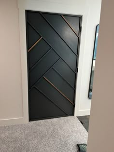 a black door with gold lines on it in a room that has carpeted flooring