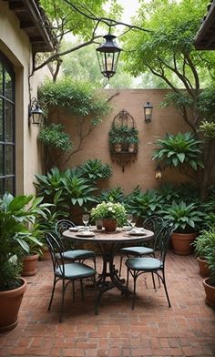 an outdoor dining area with potted plants