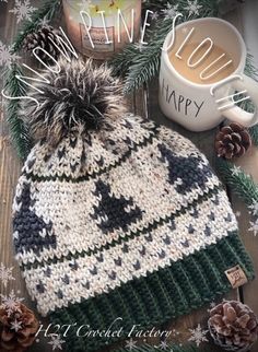 a knitted hat sitting on top of a wooden table next to a cup of coffee