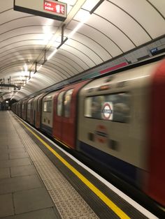 a train is coming down the tracks in a subway station