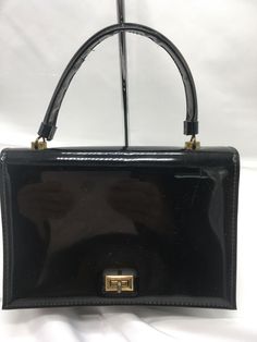 Vintage JR Florida Julius Resnick Black Patent Handbag Purse USA PLEASE READ FULL DESCRIPTION and VIEW ALL PHOTOS Some Wear, Scuffs, Scratches or Marks to Body Corners Edges Strap Brass Tone Hardware - Scratches, Wear Also Some Wear and Marks to Interior Wiped Clean No Odor Actual Measurements 9” Length 6” Height 4" Width 4.5” Carrying Handle Please Contact me before you Purchase if you have Question about Payment Please make Payment within 48 Hours close of Sale. Otherwise, item will be re-list Business Style, Formal Business, Movie Star, Handbag Purse, A Bag, Vintage Clothing, The Bag, Vintage Outfits, Top Handle Bag