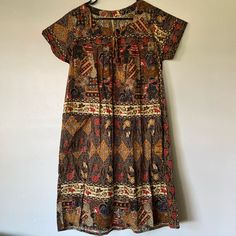 Autumn Colored, Batik Cotton Housedress, Like New And Never Worn. No Size, But Would Fit Anywhere From Small To Large Comfortably. Approx 20” Ptp, 40” Long. Possibly Handmade. Bohemian Patterned Midi Dress With Short Sleeves, Short Sleeve Patterned Dress With Paisley Print, Short Sleeve Paisley Print Patterned Dress, Bohemian Patterned Daywear Dresses, Bohemian Patterned Dresses For Daywear, Bohemian Patterned Day Dresses, Casual Boho Print Day Dress, Patterned Batik Print Short Sleeve Dress, Patterned Short Sleeve Dress With Batik Print