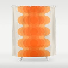 an orange and white shower curtain with circles on it