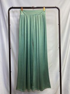 Silky SeafoamGreen Pants Like the smooth waves of the sea washing over the sand. Flow into the room with elegance in these silky mermaid-like pants. These pants are made with a silky, heavy fabric which creates a shimmery drape effect. The legs are flared and create a sleek look. The wide waistband is elastic and the fabric is also stretchy, for a flexible fit. Pleated at the front and the back. Model is 5'2" in 3-inch heels, wearing a size small. Party Stretch Satin Bottoms, Stretch Satin Bottoms For Summer, Chic Green Satin Bottoms, Elegant Green Wide Leg Pants With Elastic Waistband, Stretch Satin Bottoms For Night Out, Green Straight Pants For Evening, Green Summer Evening Pants, Summer Evening Satin Pants, Green Evening Pants For Summer