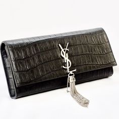 New Never Used Has Original Receipt Black Embossed Leather Saint Laurent Monogram Cassandre Clutch With Silver-Tone Hardware, Logo Adornment Featuring Tassel Embellishment At Front, Tonal Grosgrain Lining, Single Slip Pocket At Interior Wall And Snap Closure At Front Flap. Size: 11"L X 1.75"W X 5.5"H Leather, Suede Lining. Elegant Black Bag With Tassels, Elegant Black Bags With Tassels, Designer Bags With Tassels, Elegant Formal Bags With Tassels, Nude Clutch, Embossed Bag, Hardware Logo, Printed Clutch, Aquamarine Pendant