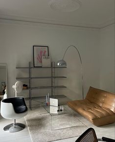 a living room filled with furniture and a large book shelf next to a chair on top of a rug