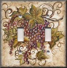 two light switch covers with grapes on the wall and vines in the middle, one is white