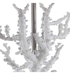 a white coral is hanging from a metal pole