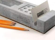 some pencils are laying next to a concrete block