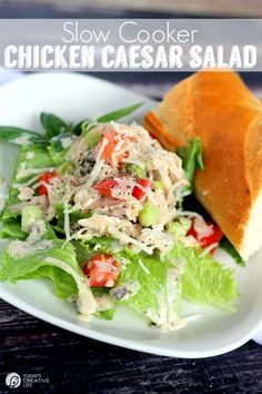 chicken caesar salad on a white plate with lettuce and tomato in the middle