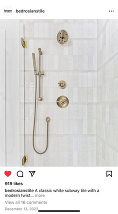 a shower with gold fixtures and white tiles on the walls, along with a tiled floor