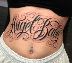 a woman's stomach with the words angel baby written on it and in cursive font