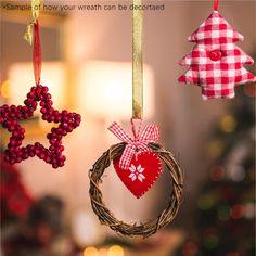 three ornaments hanging from a christmas tree in the shape of heart, wreath and star