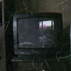 an old tv sitting on top of a wooden table