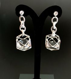 Unusual, sparkly diamond shaped crystals are captured in silver plated cages. I have joined them to the crystal, non allergenic, stainless steel posts with chain maille. Nice neutral earrings will go with anything. Makes a lovely gift. Here is a link to my whole shop: https://www.etsy.com/shop/designsbymalone RETURNS - BUY WITH CONFIDENCE Don't worry, I will refund or exchange an item up to 60 days. Makes gift giving easy! All my items will arrive in a gift box and/or a velvet or organza pouch. Party Earrings With Clear Metal, Modern Silver Crystal Earrings, Formal Metal Crystal Earrings, Modern Silver Metal Crystal Earrings, Nickel-free Crystal Earrings For Formal Occasions, Sparkling Stone Metal Earrings For Gift, Silver Crystal Earrings With Diamond Accents For Party, Silver Crystal Earrings With Sparkling Stones For Gift, Sparkling Metal Crystal Earrings For Anniversary