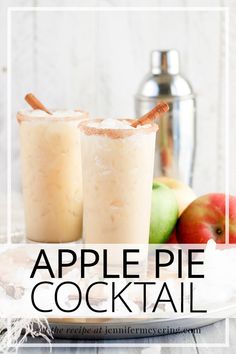 two glasses filled with apple pie cocktail on top of a white plate