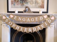 a fireplace with a sign that says engaged sophile and david on it's mantle