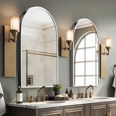 a bathroom with double sinks and mirrors in the wall, along with two lights on either side of the mirror