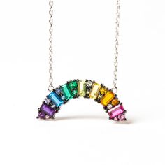 Bring a little hope and color into your wardrobe with this stunning Rainbow CZ "Hope" Baguette Crystal Necklace. This gorgeous necklace features an elegant, rainbow-shaped design crafted from a rainbow of cubic zirconia crystals. The subtle sparkle and pop of color is sure to brighten up any look. The necklace is adjus Cheap Rainbow Dangle Jewelry, Rainbow Jewelry Aesthetic, Rainbow Cubic Zirconia Necklaces For Gift, Rainbow Cubic Zirconia Necklaces As Gift, Rainbow Cubic Zirconia Necklace For Gift, Colorful Jewelry Aesthetic, Crystal Aesthetic, Nail Jewels, Origami Owl Jewelry