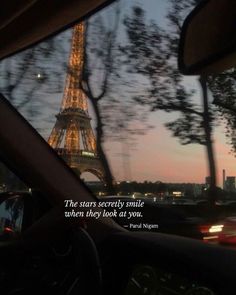 the eiffel tower is seen from inside a car