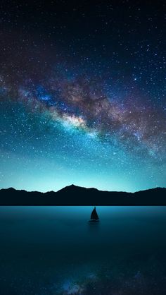 the night sky is filled with stars and milky over mountains, reflecting in calm water