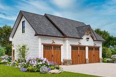 a white house with two brown garage doors and flowers in the front yard on a sunny day