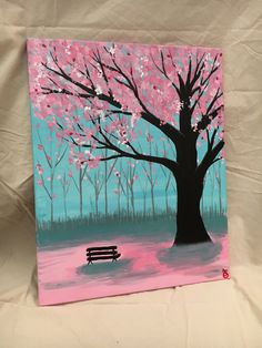 a painting of a park bench under a tree with pink flowers on it and blue sky in the background