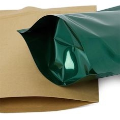 a green plastic bag sitting on top of brown paper