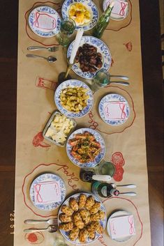 the table is set with many dishes and utensils, including an assortment of food