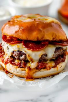 a cheeseburger with meat and sauce on it