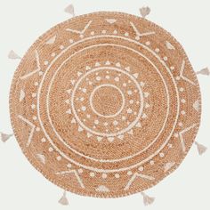 a round woven rug with tassels on it