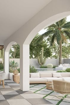 an outdoor living area with white furniture and potted plants on the wall, surrounded by palm trees