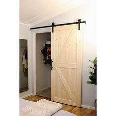 an open sliding barn door in a bedroom