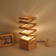 a lamp made out of wooden blocks on a table