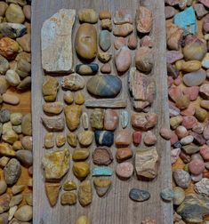 various rocks and stones laid out on a wooden board