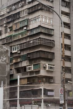 an apartment building with balconies on the top floor