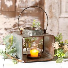 an old metal lantern with a candle inside