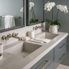 A gray floating dual sink vanity topped with a light gray quartz countertop is accented with polished nickel pulls and polished nickel faucets mounted to a light gray quartz backsplash under galvanized metal framed medicine cabinets fixed to gray walls. Floating Marble Sink, Floating Sink Vanity, Grey Grasscloth Wallpaper, Grey Quartz Countertop, Polished Nickel Faucet, Quartz Sink, Quartz Backsplash, Two Is Better Than One, New England Home