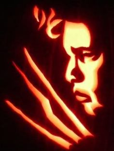 a carved pumpkin with a man's face and hands in the shape of a hand