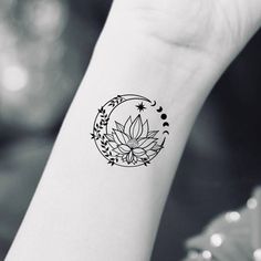 a woman's wrist with a flower tattoo on the left side of her arm