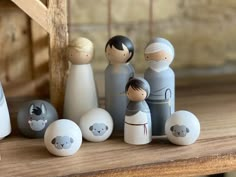 a group of small figurines sitting next to each other on a wooden table