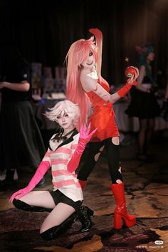 two women dressed in cosplay costumes pose for the camera