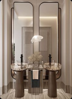 a bathroom with two sinks and mirrors in the middle of it, along with a vase filled with flowers