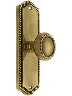 an antique brass door handle with roped design on the front and side handles,