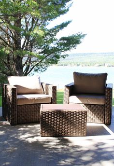 wicker furniture sitting on a patio next to a tree