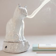 Created by Astier de Villatte in collaboration with Countess Setsuko Klossowska de Rola, a painter (and widow of the painter Balthus). Set the incense in the base of the cat, watch it languidly pour from it's mouth. Wal Art, Tanah Liat, Sukkot, Incense Holders, Incense Holder, Cool Stuff, Incense Burner, White Cat, Clay Crafts