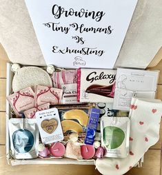 an open gift box filled with personal care items and greeting cards for someone's special occasion